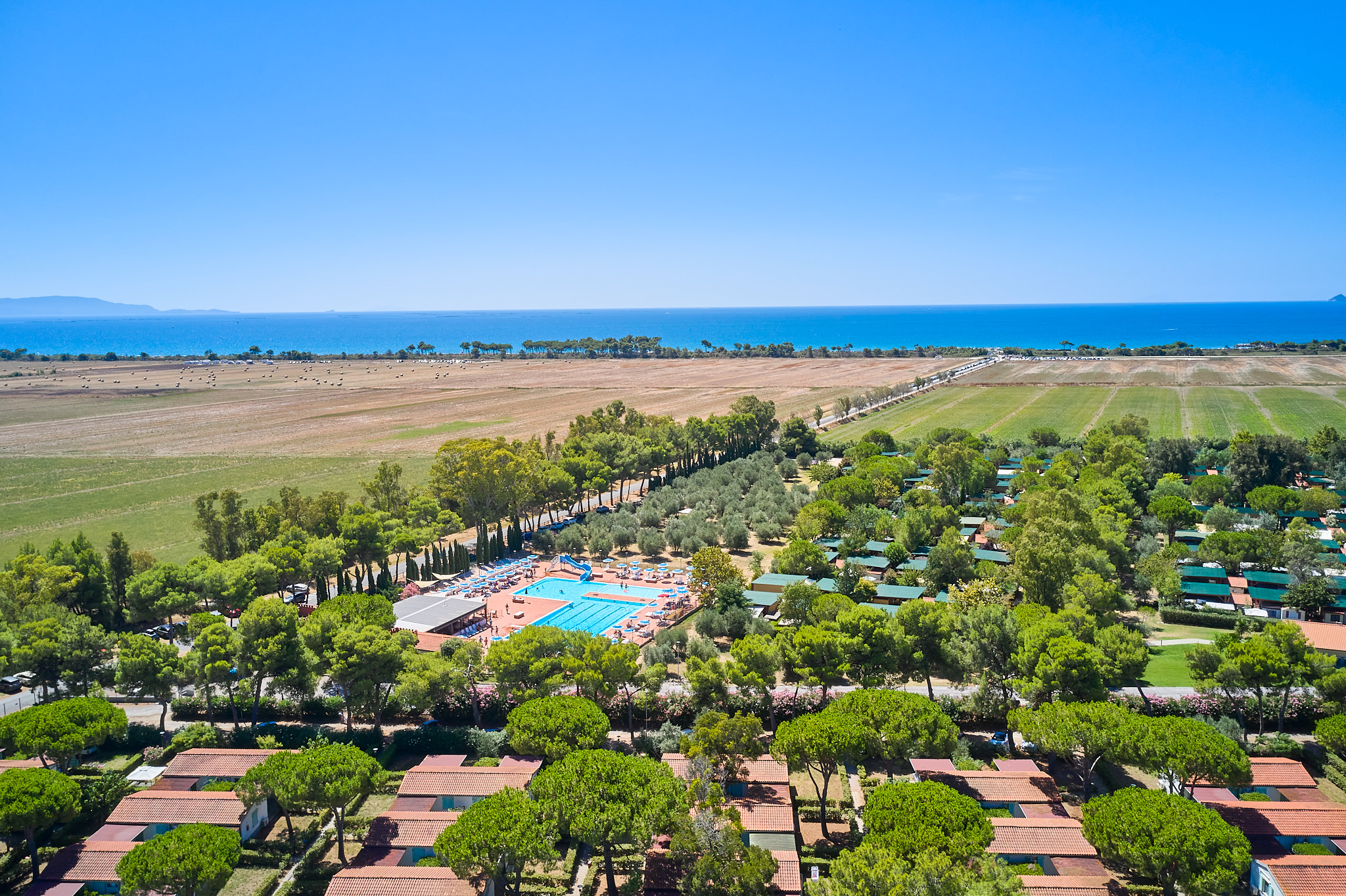 Villaggio Orizzonte — cyclist pausing in a sunlit green field