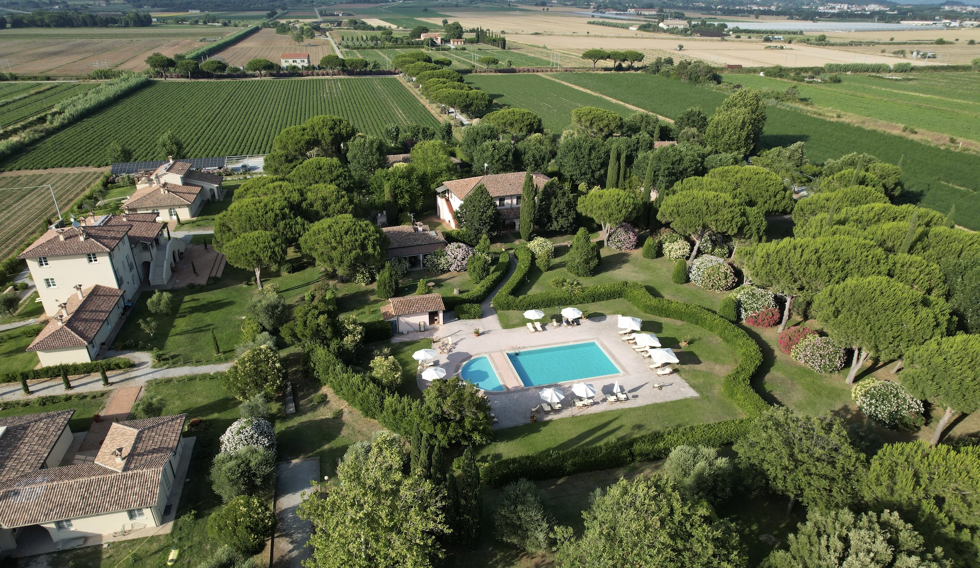 Villa Toscana — aerial view of the villa with pool surrounded by Tuscan countryside